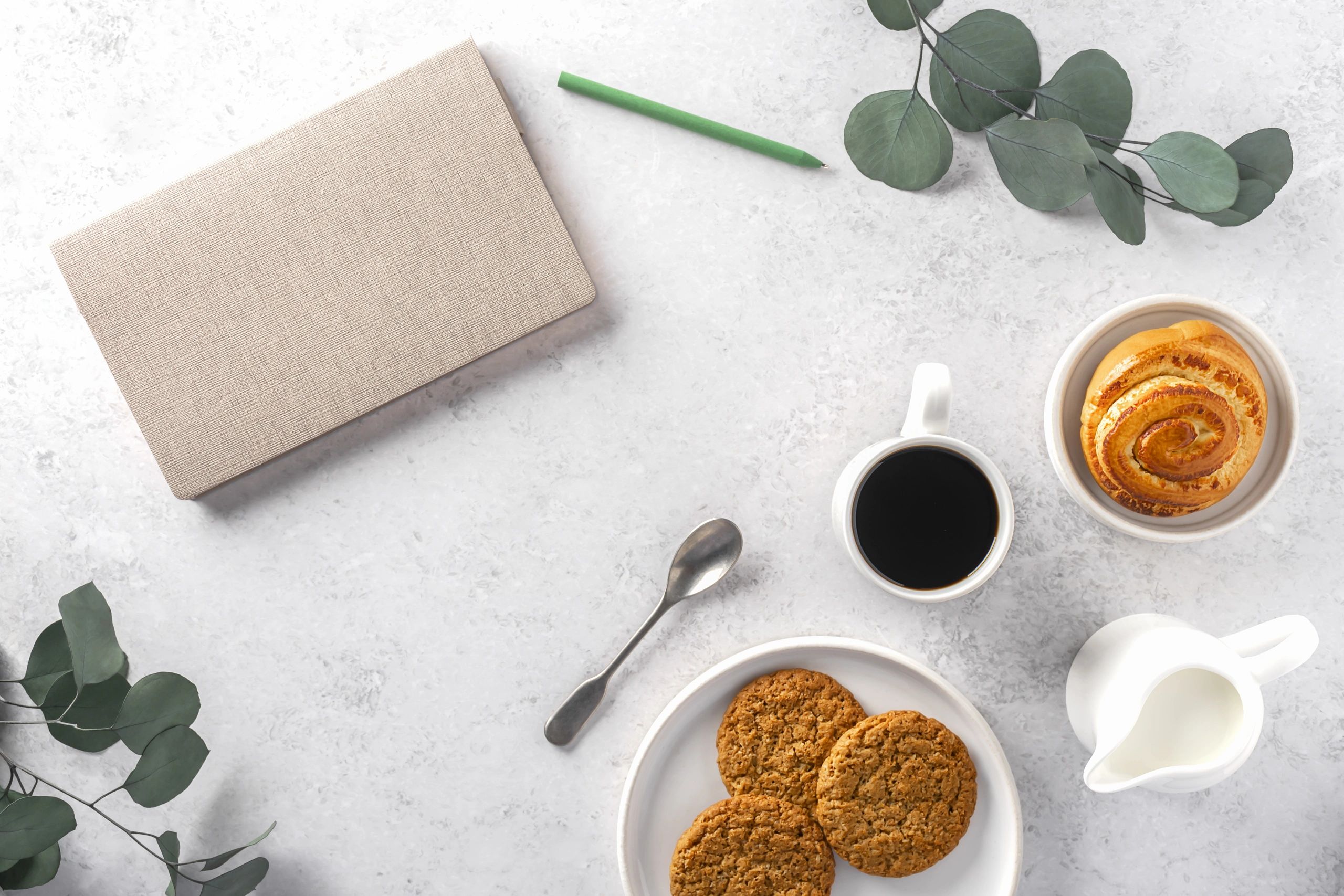 Cozy editorial flat lay with coffee, notebook, and soft neutral tones