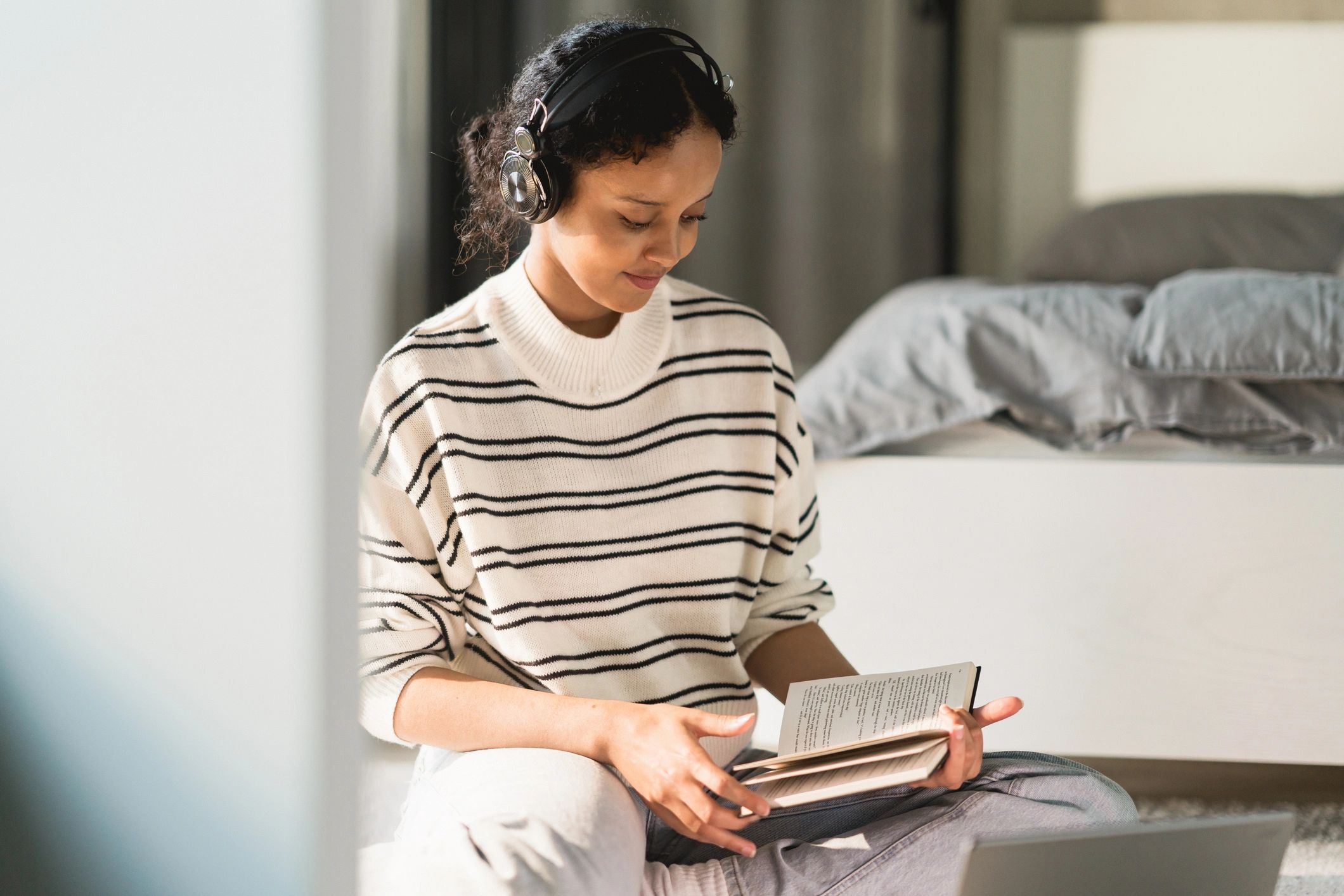 Woman reading at home in a calm, cozy setting