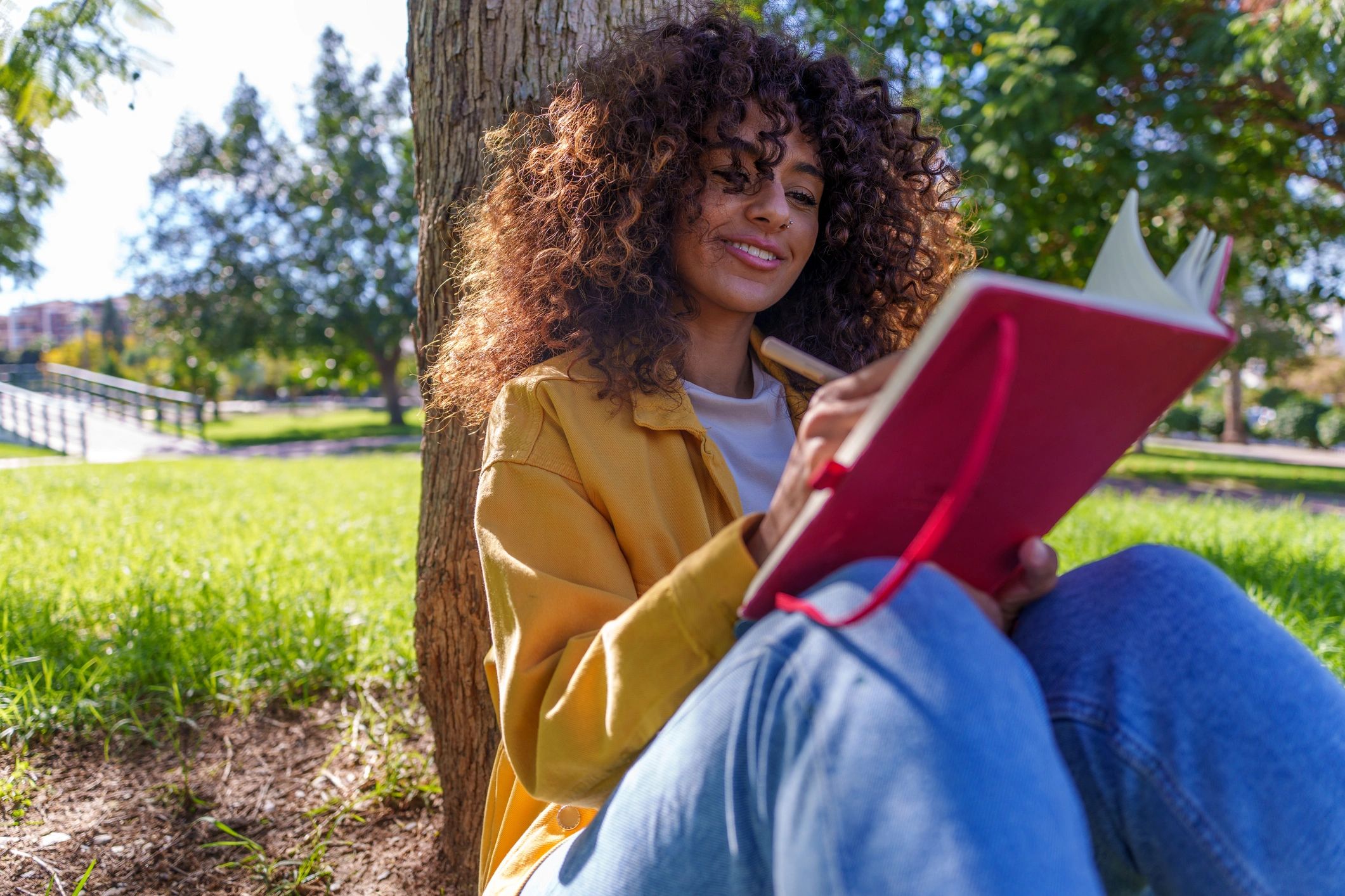 Woman journaling outdoors during a peaceful learning moment