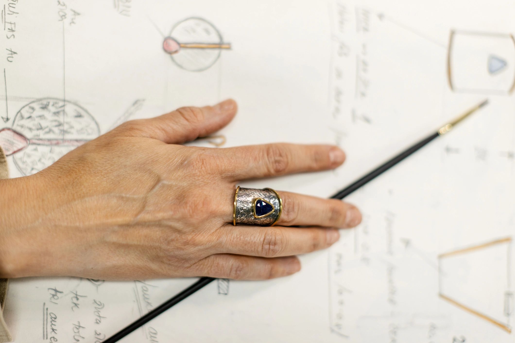 Woman designing jewelry in her atelier